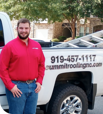 Summit roofing truck and phone number, with Brantley Blanchard Jr. standing next to it | Summit Roofing
