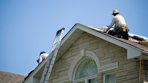 Roofers shingling roof | Summit Roofing